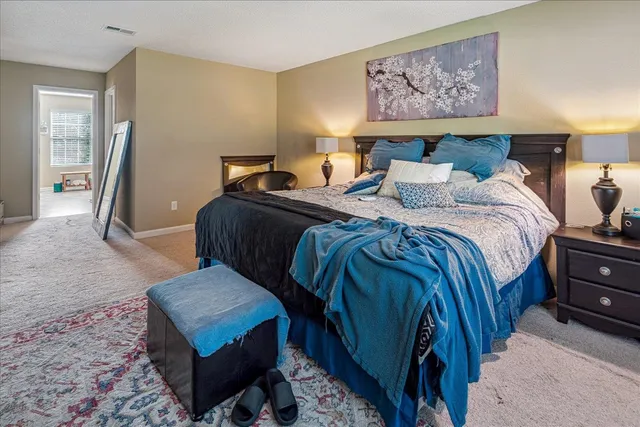 a bed room with a bed and painting on the wall