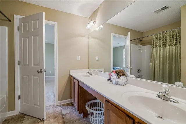 a bathroom with a sink double vanity and a mirror