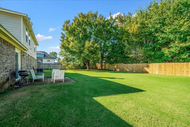a view of a chair and table in the garden