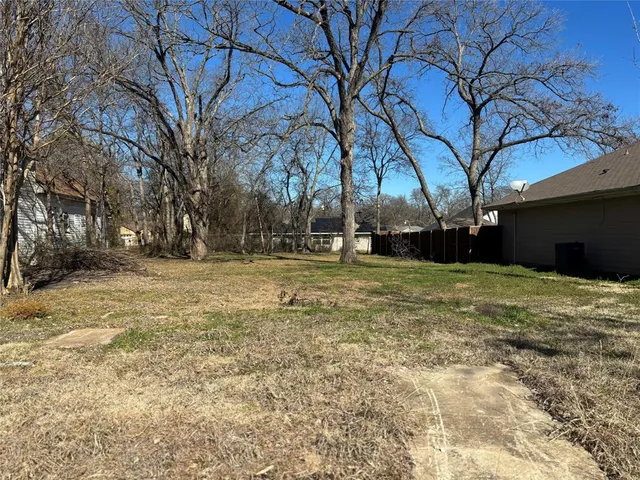 a backyard of a house with large trees