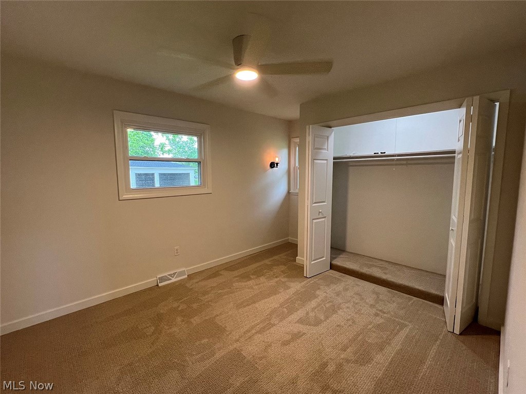 550 Johnson Road Wadsworth, OH 44281 - Photo 17 of 40 Unfurnished bedroom featuring a closet, ceiling fan, and light carpet