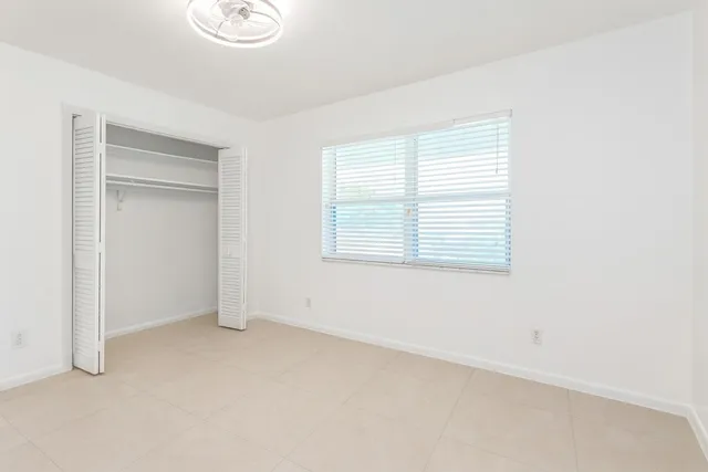 a bathroom with a granite countertop sink toilet and a mirror