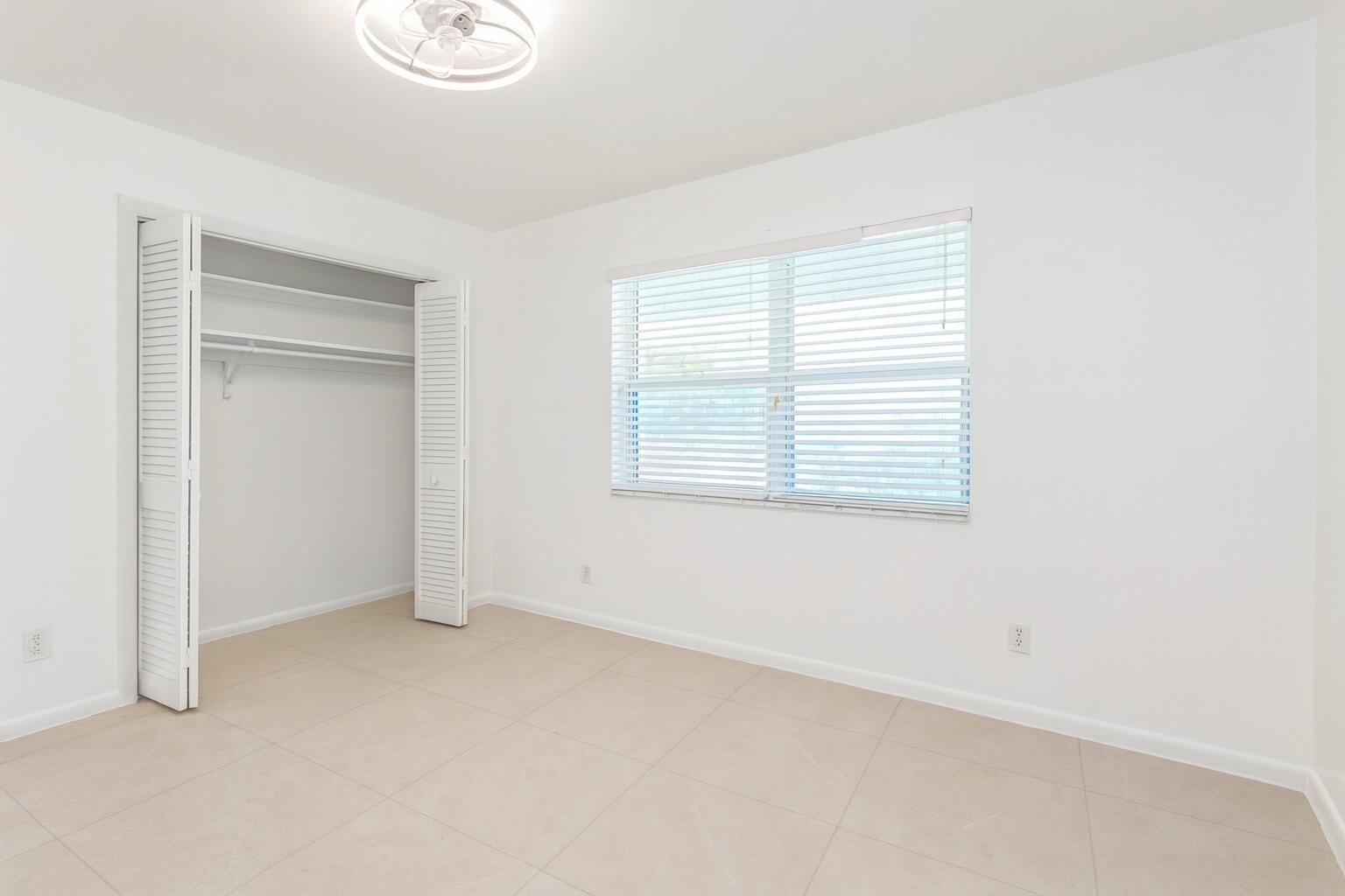 1217 Surf Road, Unit 2 Singer Island, FL 33404 - Photo 12 of 18 a view of an empty room with a window