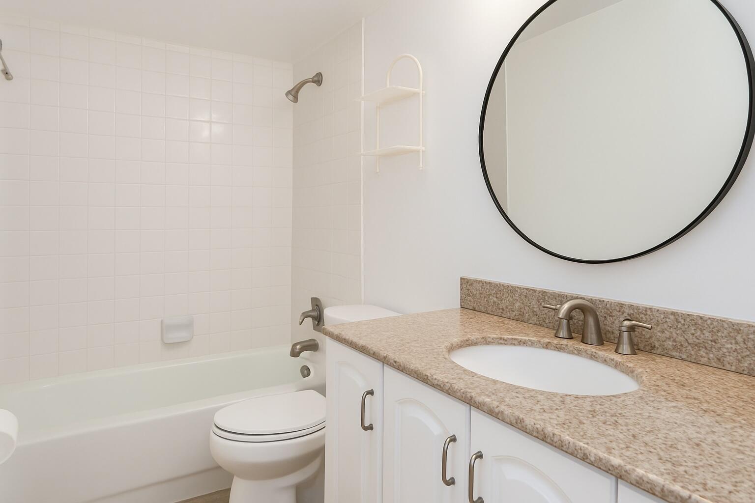 1217 Surf Road, Unit 2 Singer Island, FL 33404 - Photo 13 of 18 a bathroom with a granite countertop sink toilet and a mirror