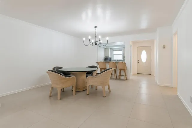 a dining room with furniture and chandelier