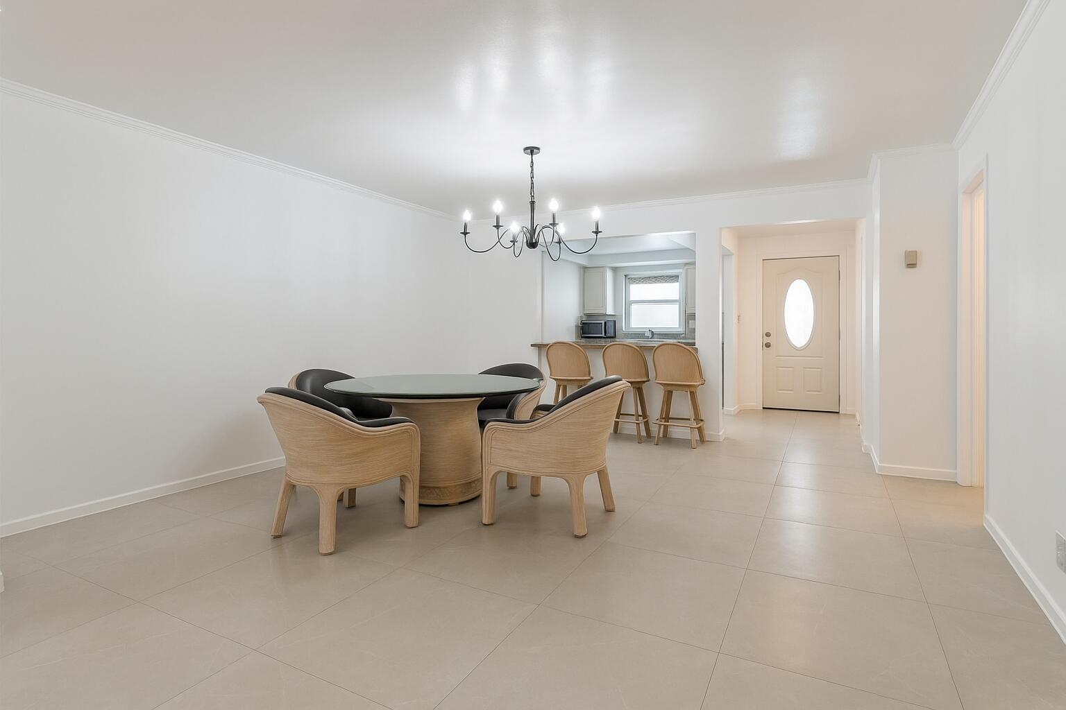 1217 Surf Road, Unit 2 Singer Island, FL 33404 - Photo 2 of 18 a dining room with furniture and chandelier