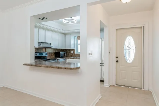 a view of kitchen with sink and cabinets