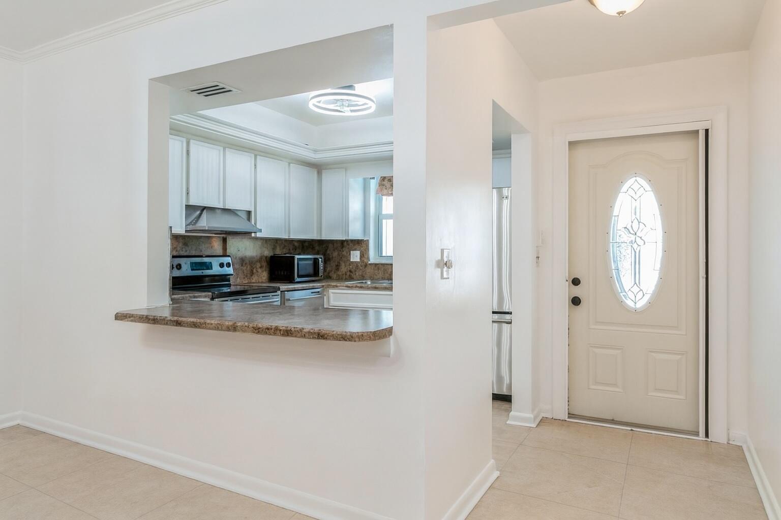 1217 Surf Road, Unit 2 Singer Island, FL 33404 - Photo 3 of 18 a view of kitchen with sink and cabinets