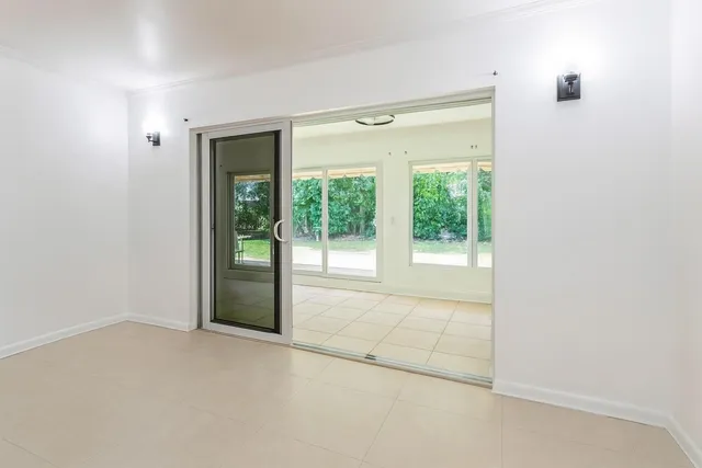 a view of an empty room with glass door