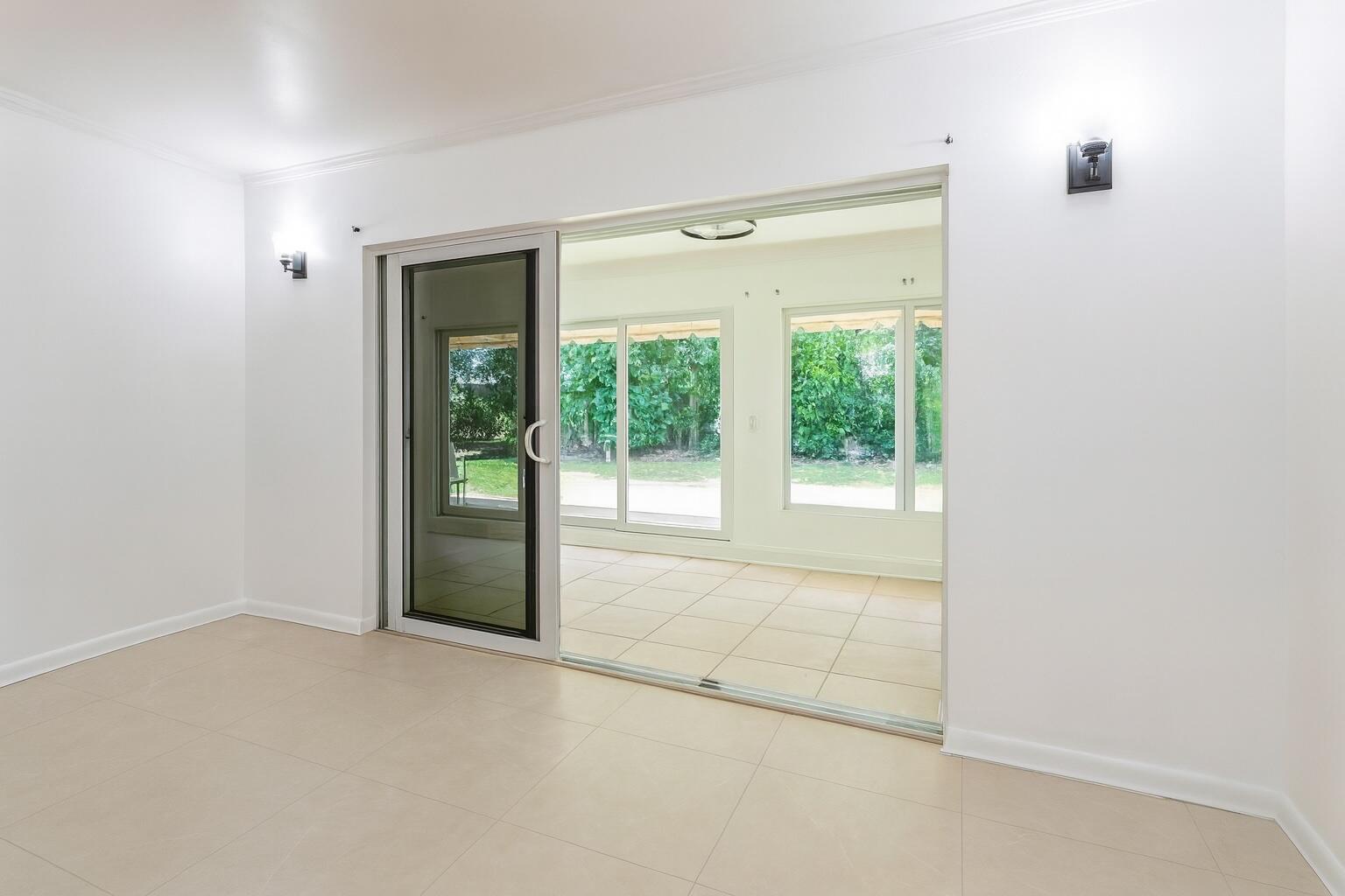 1217 Surf Road, Unit 2 Singer Island, FL 33404 - Photo 7 of 18 a view of an empty room with glass door