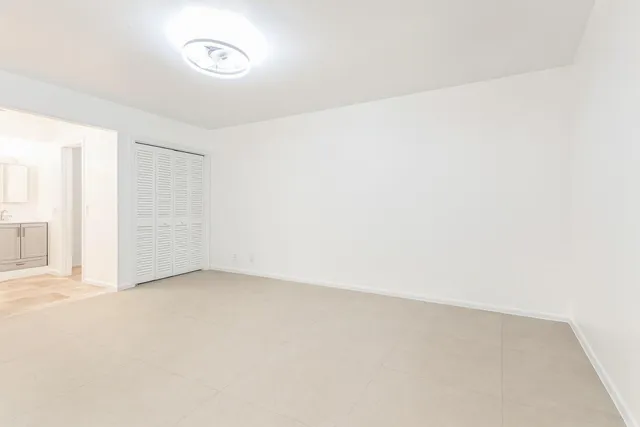 a white toilet sitting next to a shower