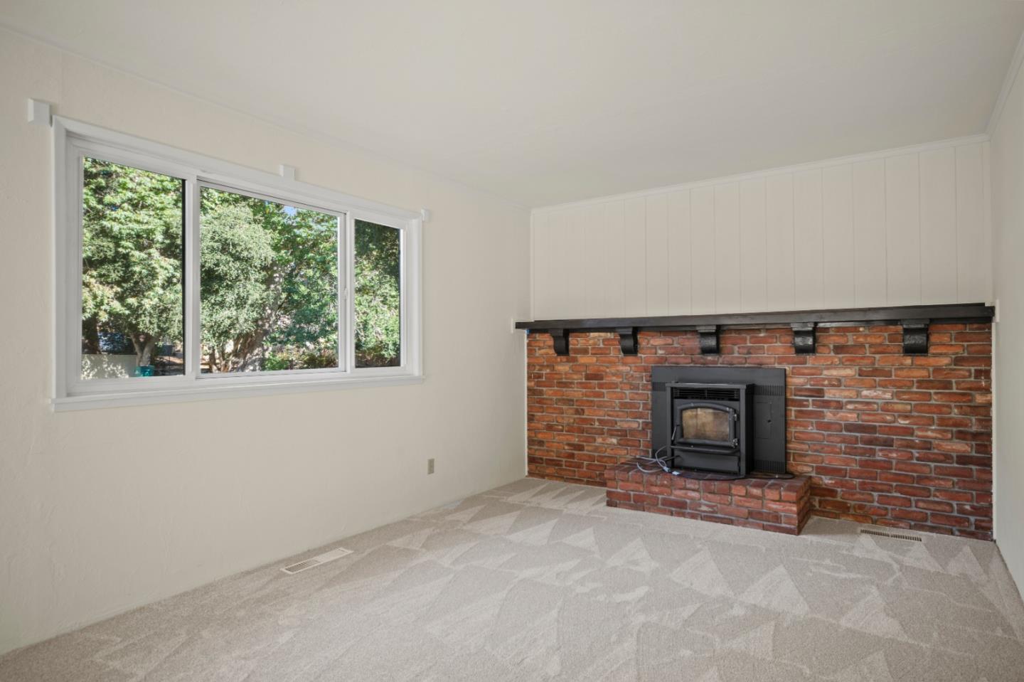 59 Boronda Road Carmel Valley, CA 93924 - Photo 20 of 43 an empty room with a fireplace and window