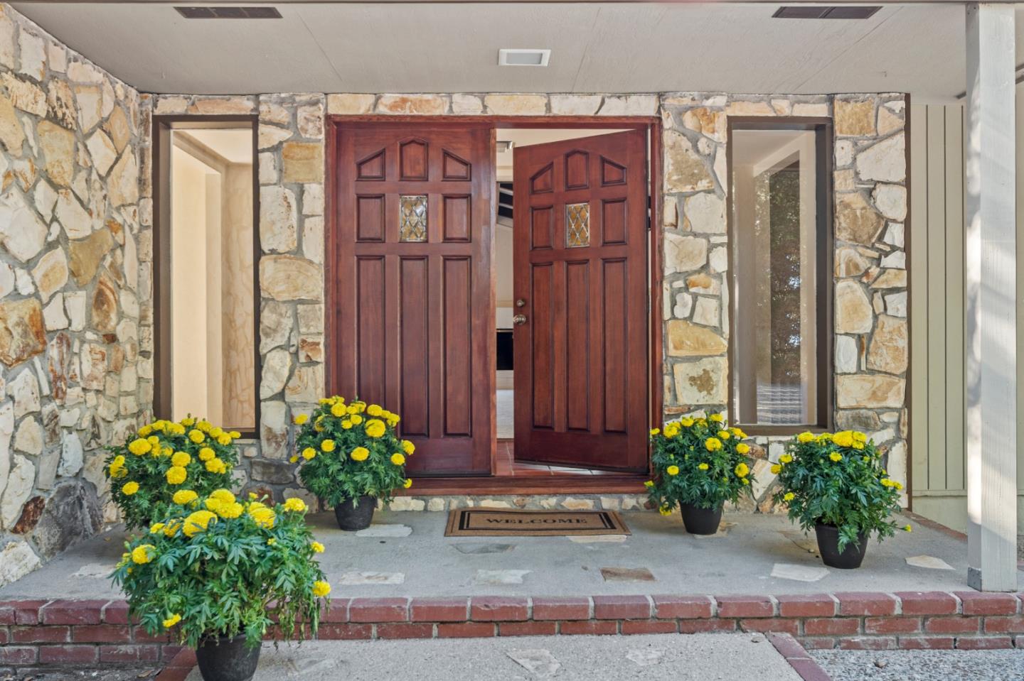 59 Boronda Road Carmel Valley, CA 93924 - Photo 3 of 43 a view of a entryway with flower pots