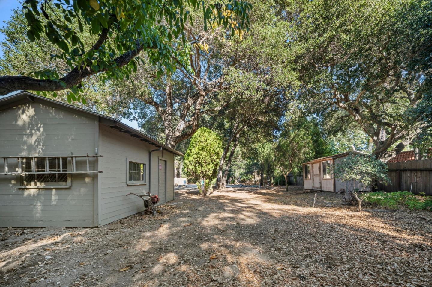 59 Boronda Road Carmel Valley, CA 93924 - Photo 34 of 43 a backyard of a house with wooden fence and large trees