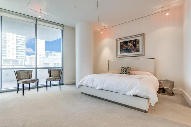 a bedroom with a bed furniture and a large window