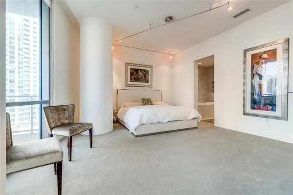 a spacious bedroom with a bed and a couch