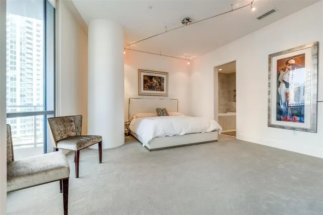 a spacious bedroom with a bed and a couch