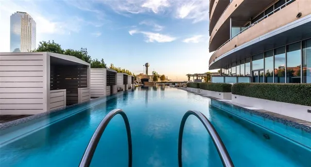a view of swimming pool with outdoor seating and plants