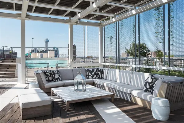 a balcony with furniture and a potted plant