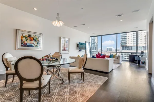 a living room with patio furniture and a wooden floor