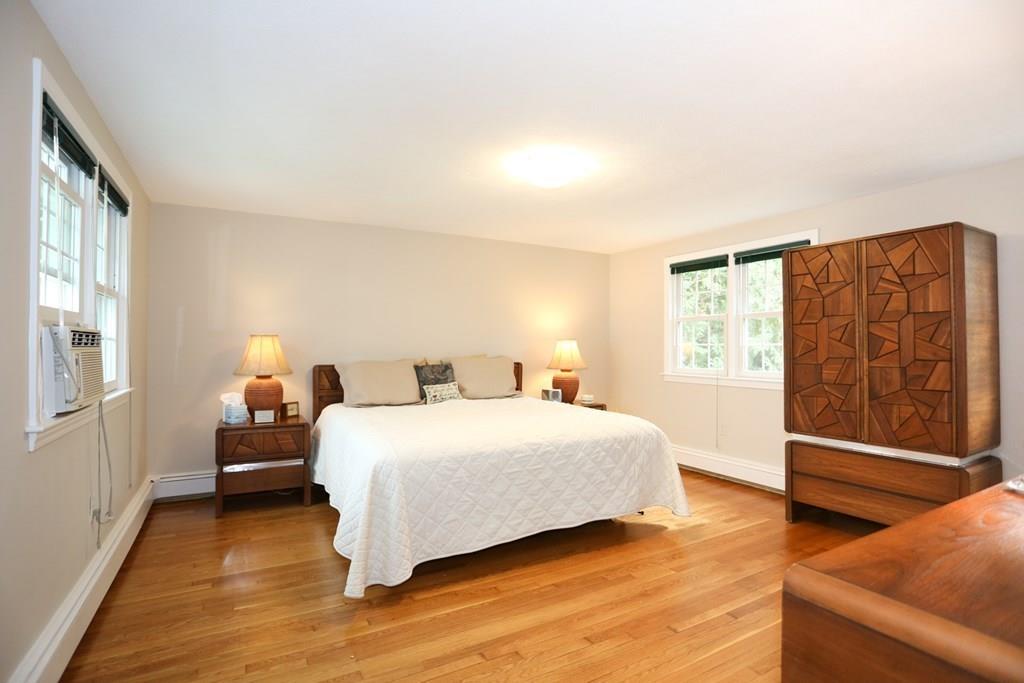 69 Border Road Needham, MA 02492 - Photo 8 of 20 a bedroom with a bed and wooden floor