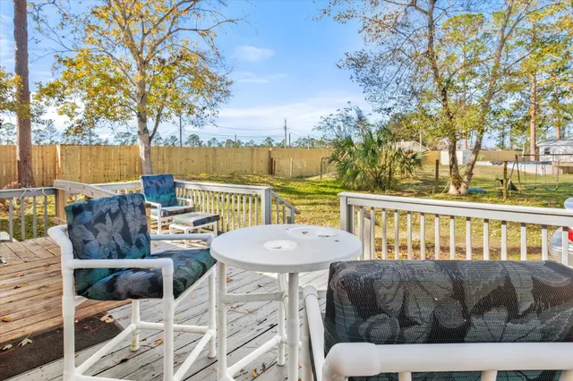 a view of a chairs and table in the roof deck