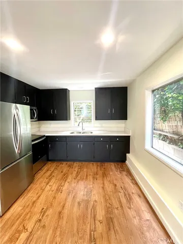 a bathroom with a large tub a sink and a large mirror