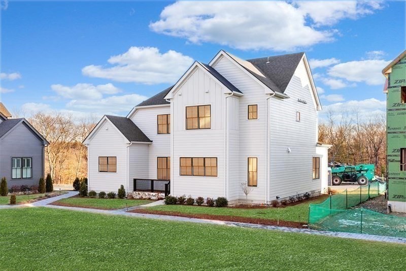 8 Common Court Lexington, MA 02421 - Photo 27 of 31 a front view of a house with a yard
