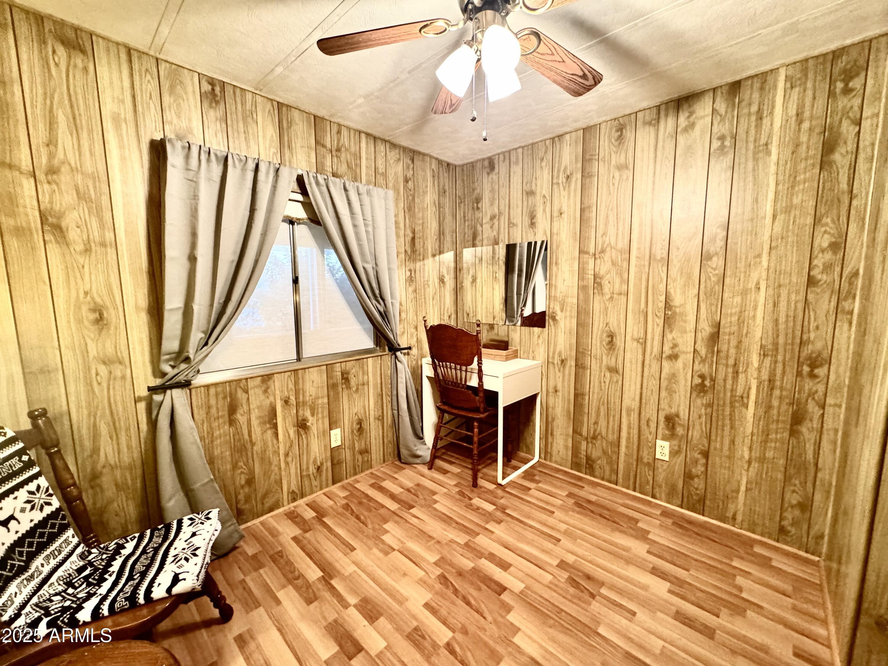 303 South Recker Road, Unit 215 Mesa, AZ 85206 - Photo 11 of 19 a view of a bedroom with wooden floor and furniture