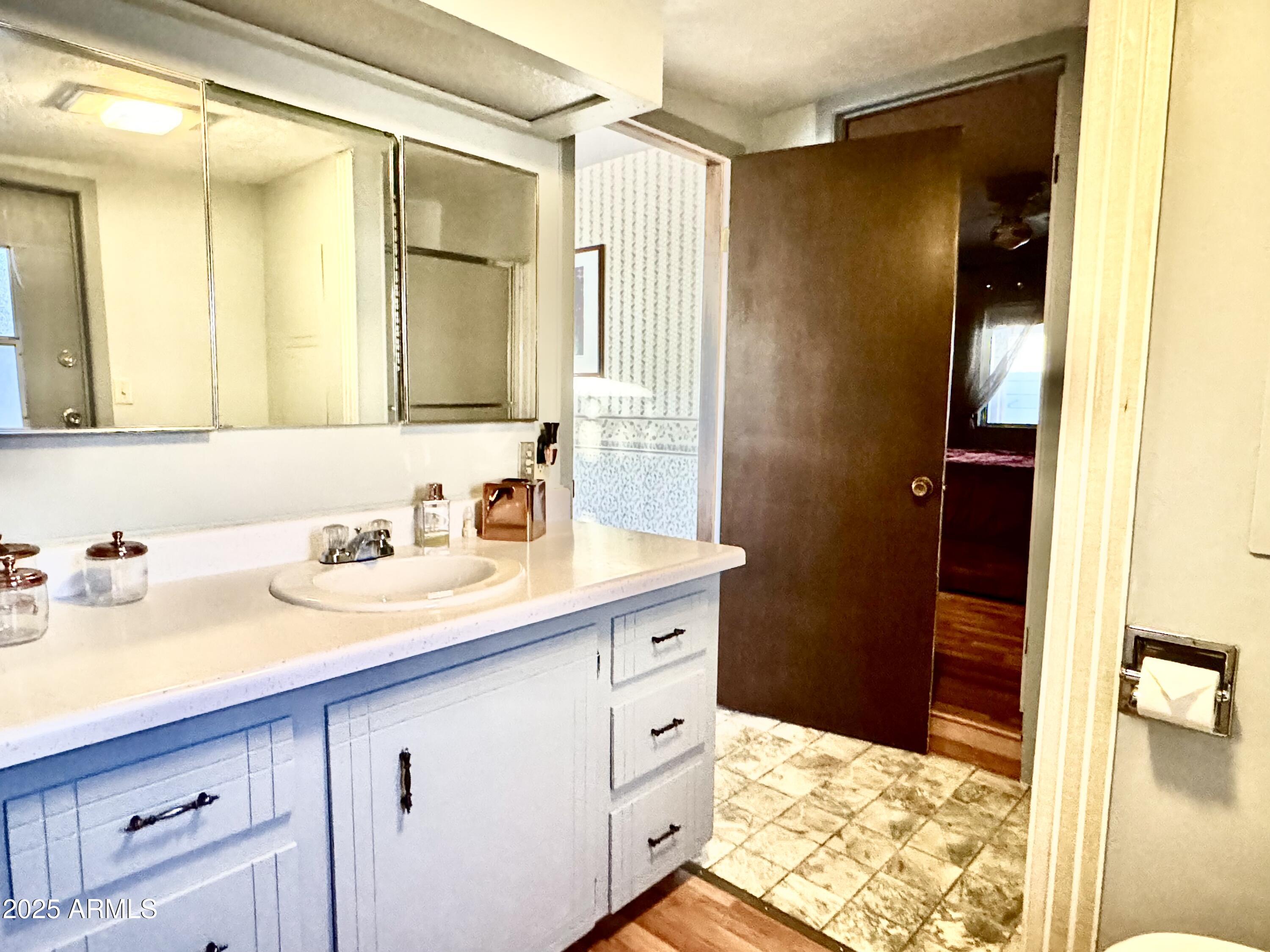 303 South Recker Road, Unit 215 Mesa, AZ 85206 - Photo 13 of 19 a bathroom with a sink and a mirror