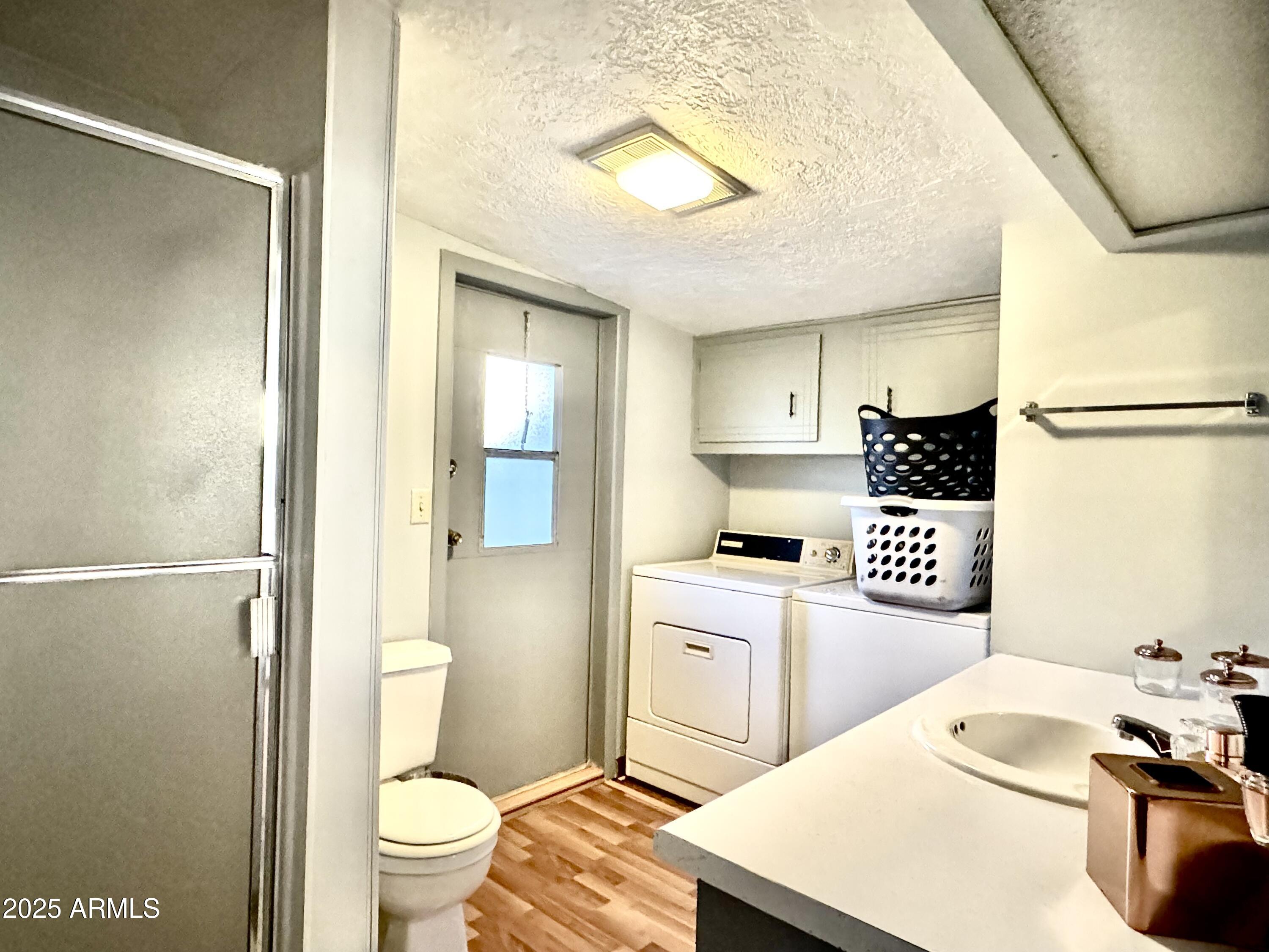 303 South Recker Road, Unit 215 Mesa, AZ 85206 - Photo 14 of 19 a kitchen with a sink a toilet and refrigerator