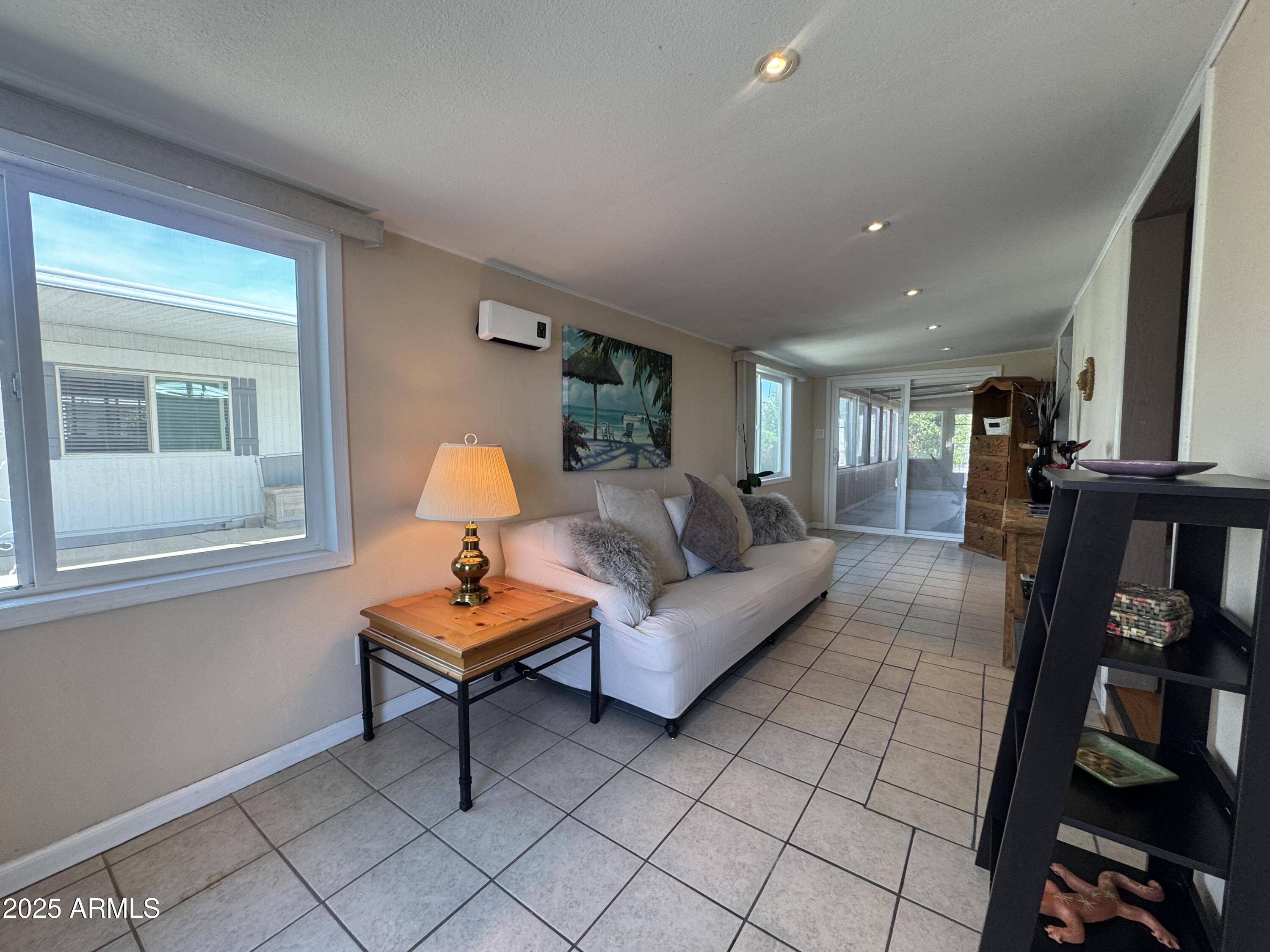 303 South Recker Road, Unit 215 Mesa, AZ 85206 - Photo 3 of 19 a living room with furniture and a window