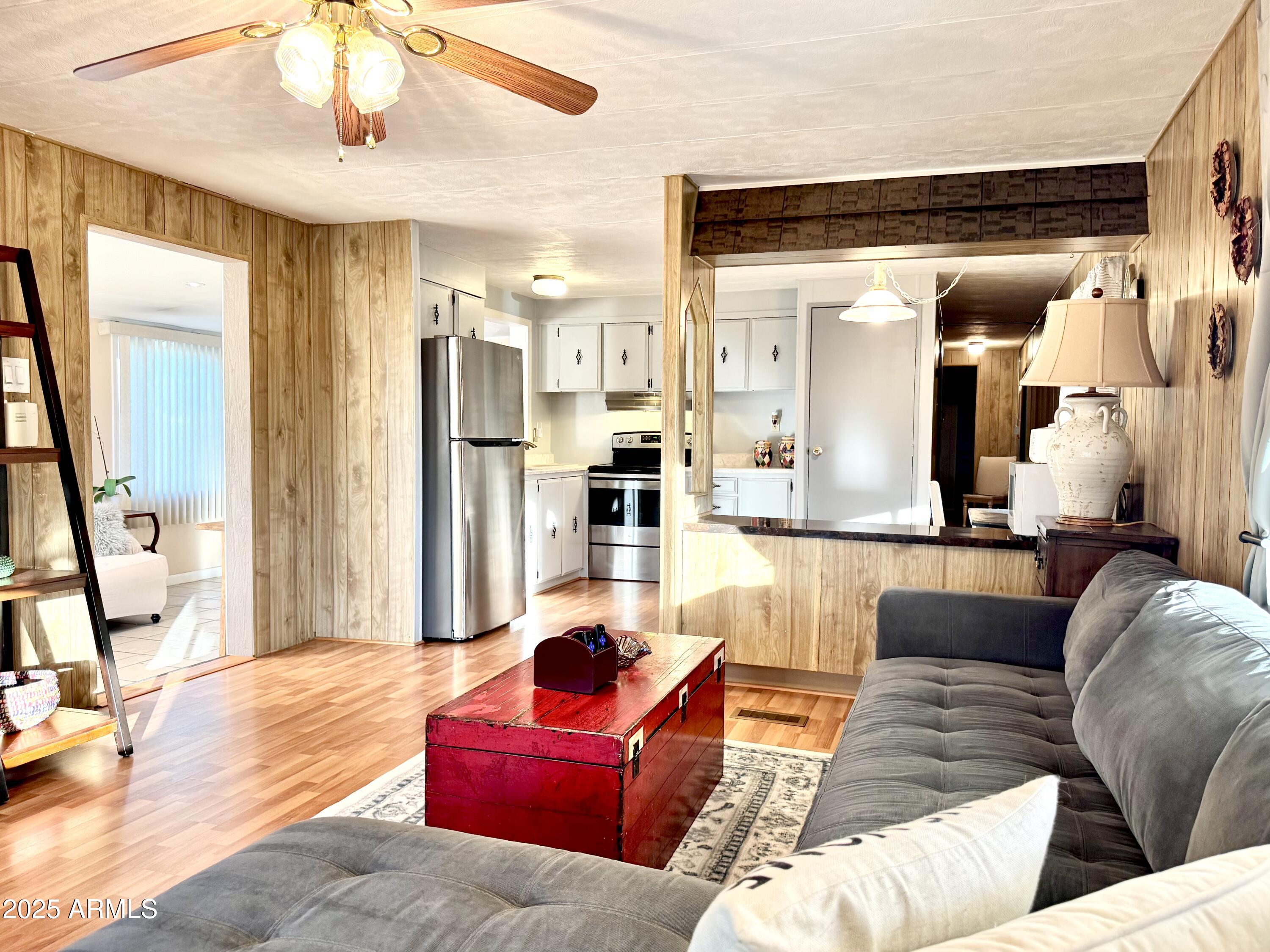 303 South Recker Road, Unit 215 Mesa, AZ 85206 - Photo 6 of 19 a living room with furniture and a flat screen tv