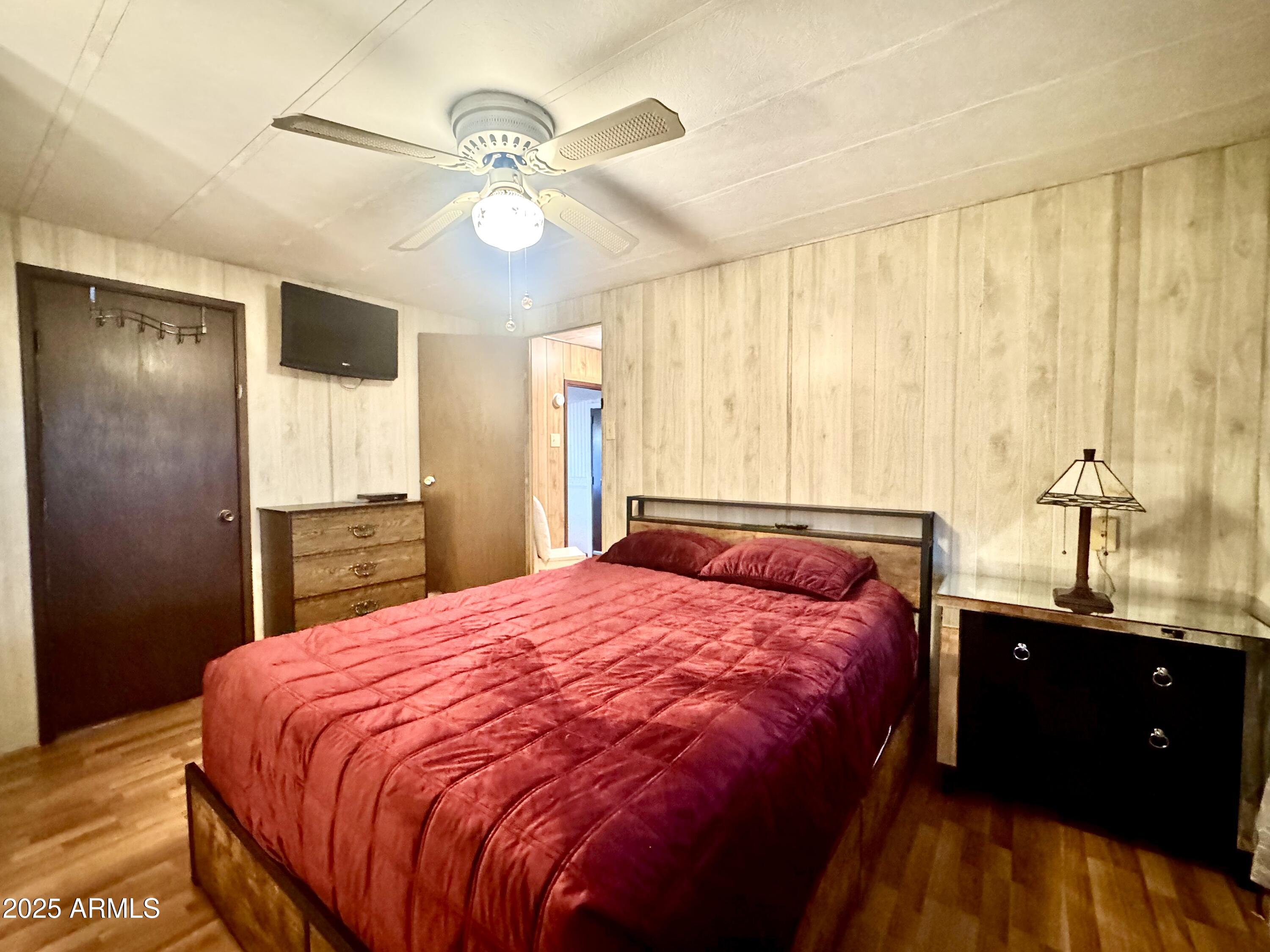 303 South Recker Road, Unit 215 Mesa, AZ 85206 - Photo 9 of 19 a bedroom with a large bed and a chandelier