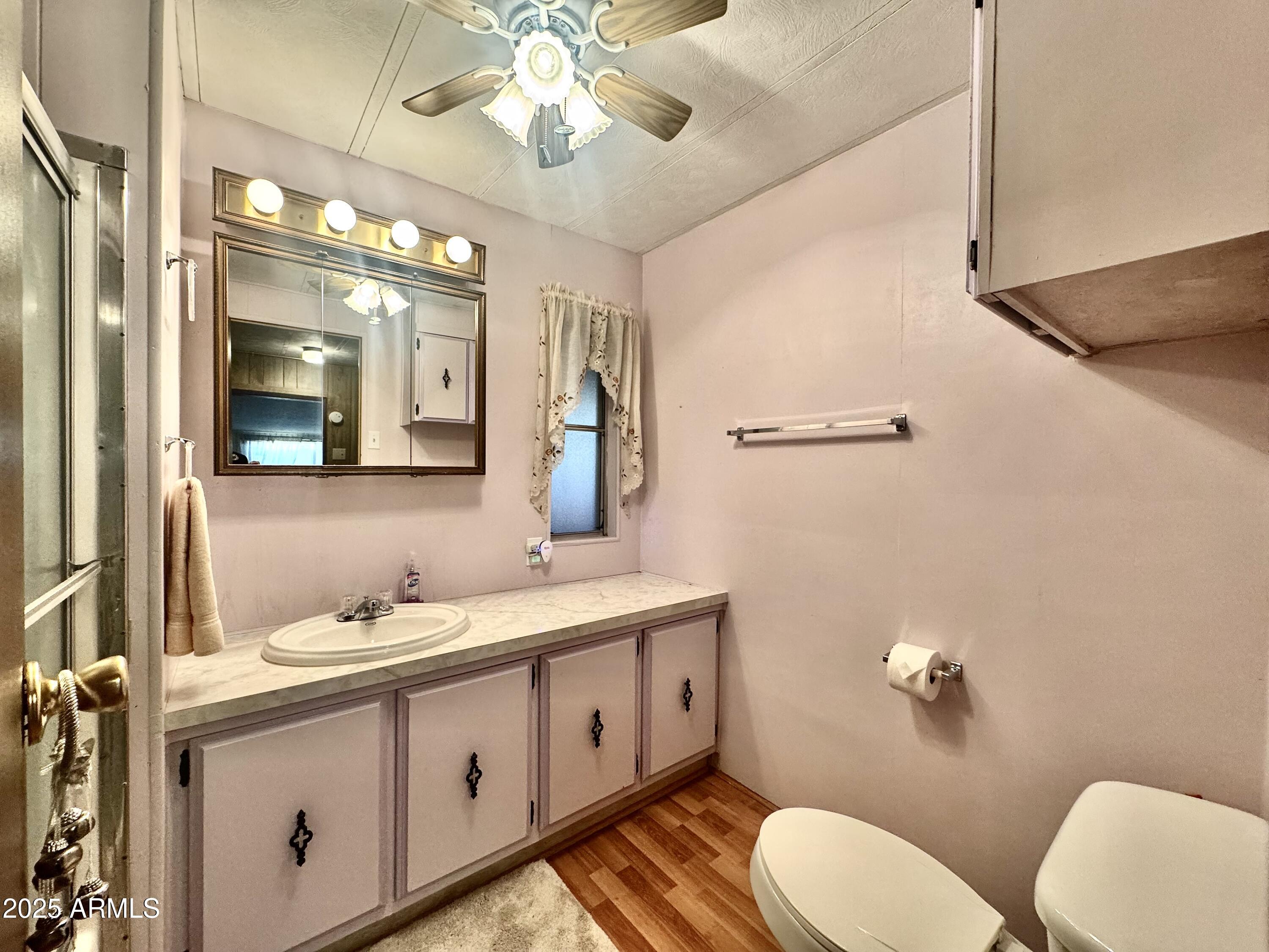 303 South Recker Road, Unit 215 Mesa, AZ 85206 - Photo 10 of 19 a spacious bathroom with a double vanity sink a toilet a mirror and shower