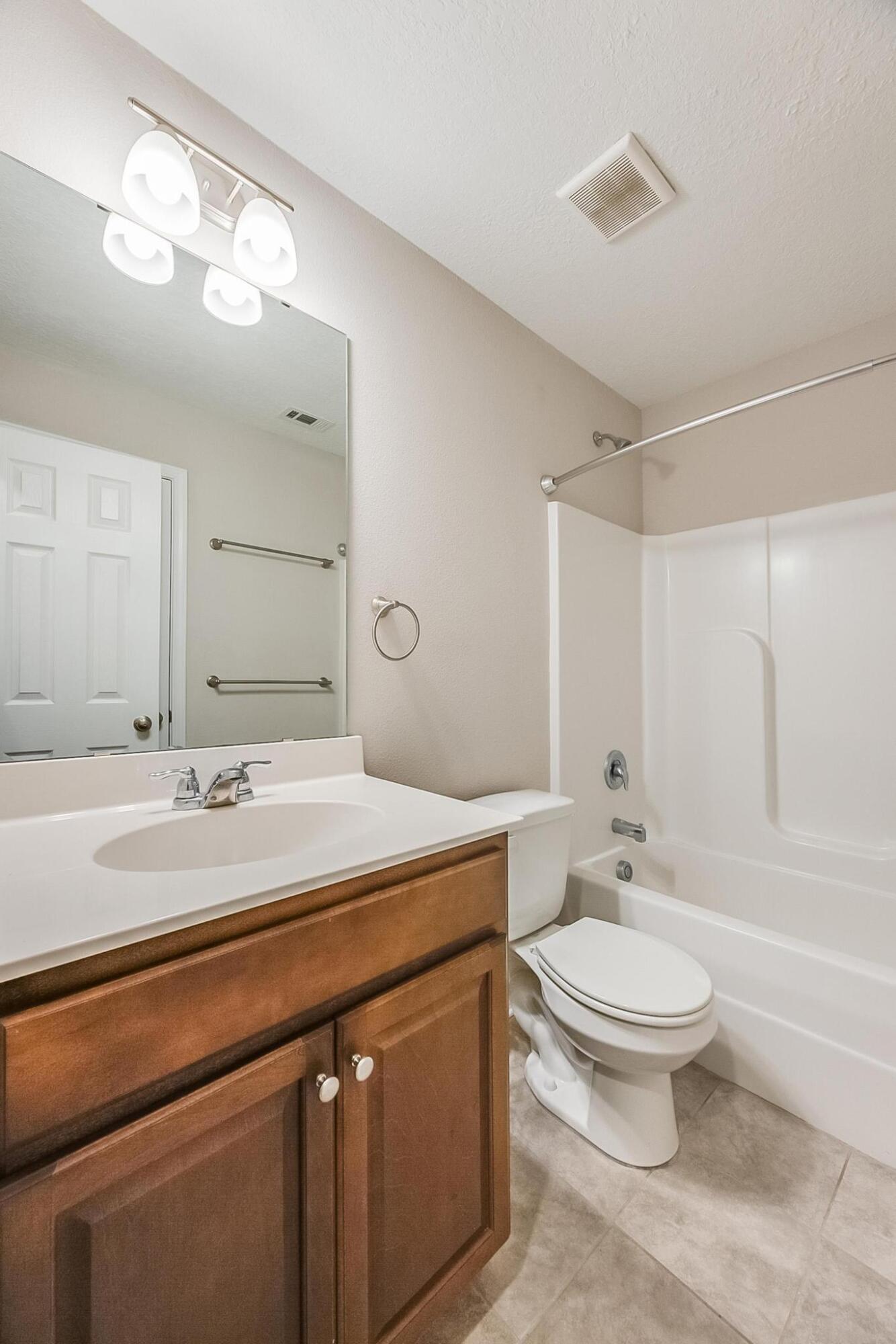 1870 Wadsworth Road Baker, FL 32531 - Photo 26 of 38 a bathroom with a sink a toilet a mirror and shower