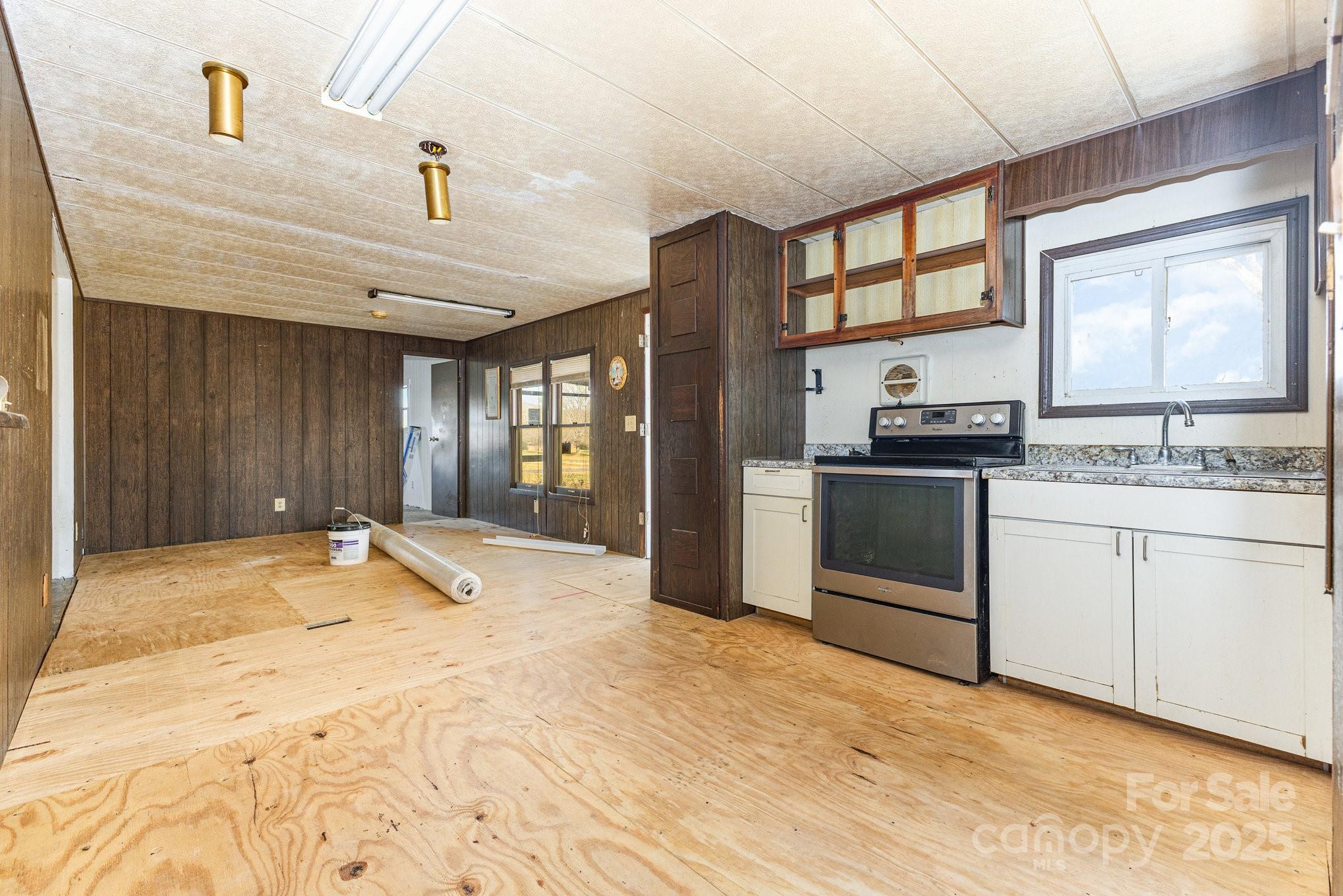 610 Osteen Road York, SC 29745 - Photo 12 of 42 a kitchen with stainless steel appliances kitchen island granite countertop a stove a sink and a refrigerator