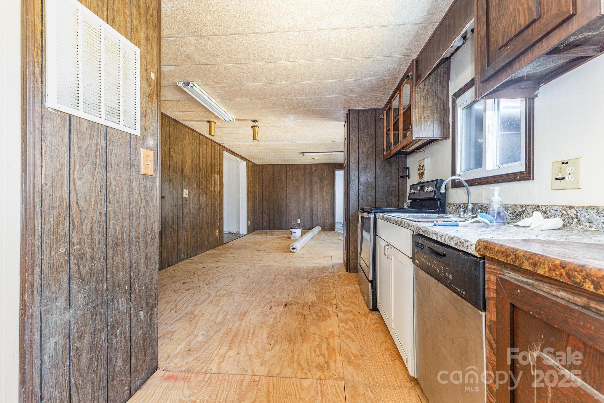 610 Osteen Road York, SC 29745 - Photo 13 of 42 a large kitchen with stainless steel appliances granite countertop a sink and cabinets