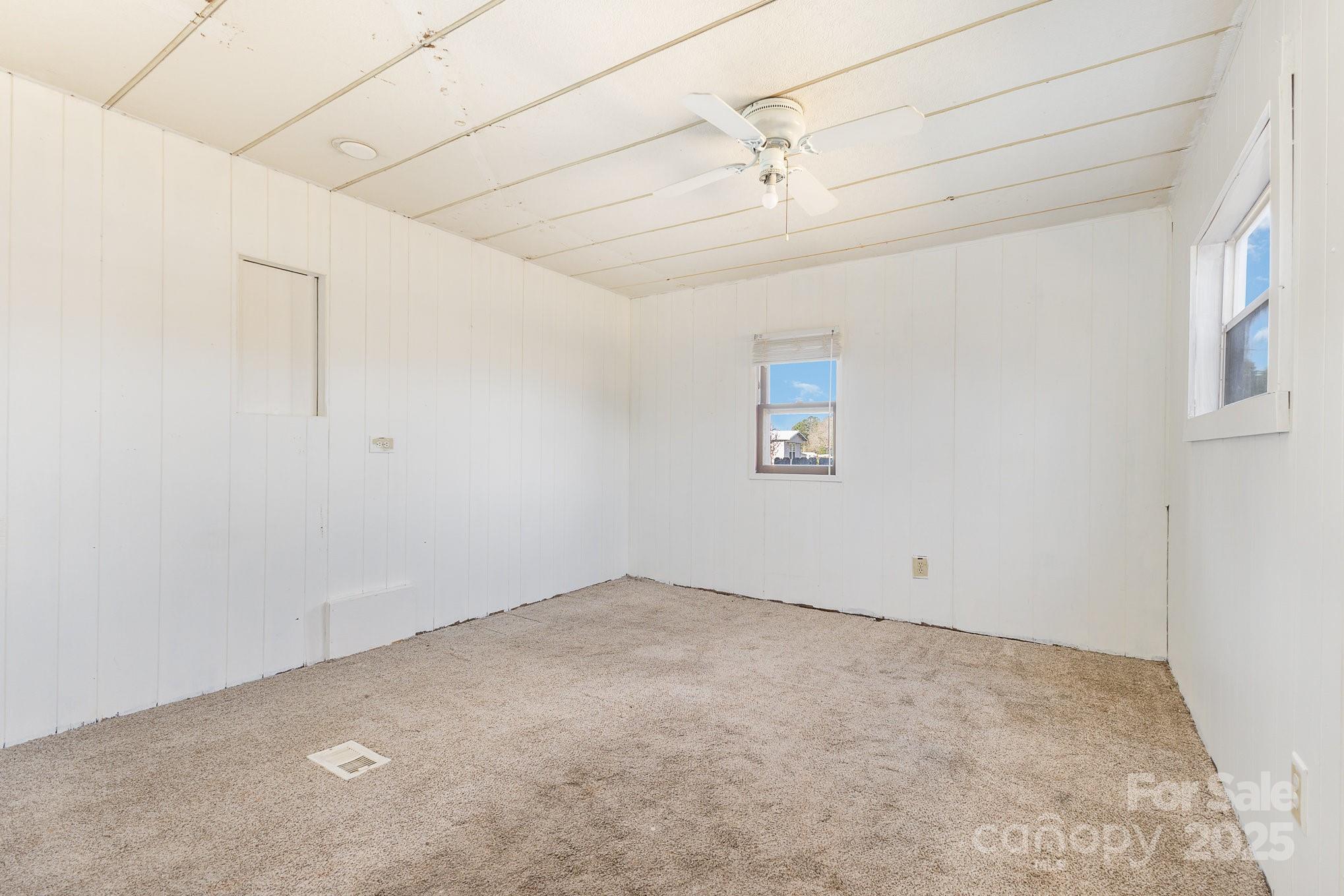 610 Osteen Road York, SC 29745 - Photo 16 of 42 an empty room with a ceiling fan and windows