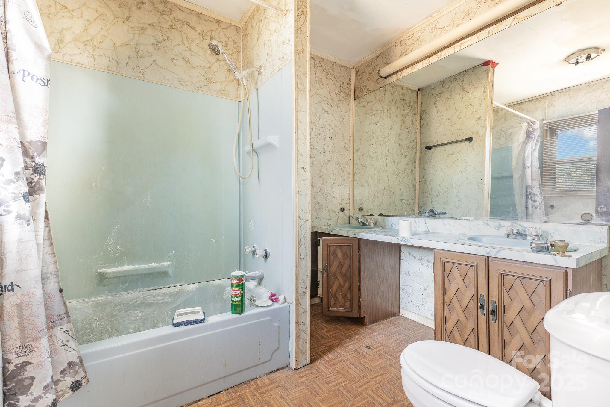 610 Osteen Road York, SC 29745 - Photo 25 of 42 a bathroom with a granite countertop sink toilet mirror and bathtub