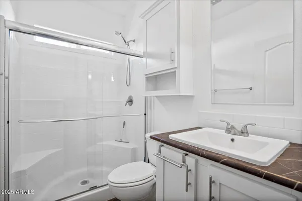 a bathroom with a sink toilet and shower