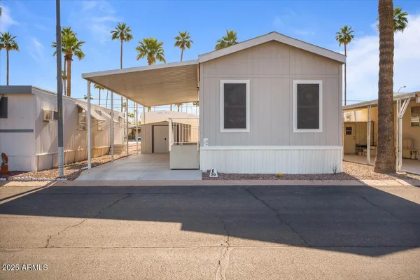 a view of a white house with a street