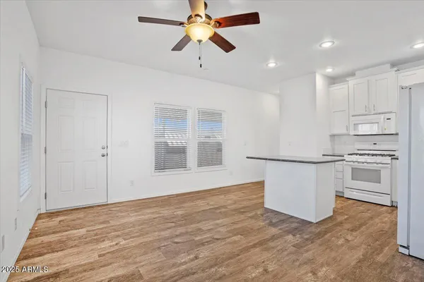 a view of kitchen with sink and refrigerator