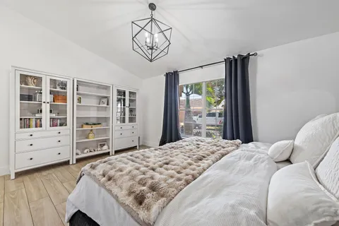 a bedroom with a bed closet and flat tv screen