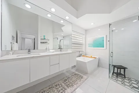 a bathroom with a sink mirror and a bathtub