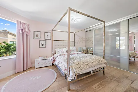 a bedroom with a bed and a mirror