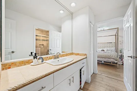a en suite bathroom with a double vanity sink and a mirror