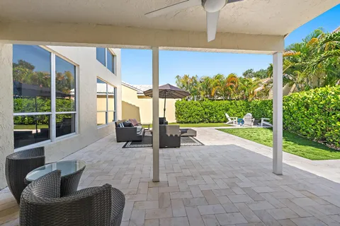 a building outdoor space with patio furniture and potted plants