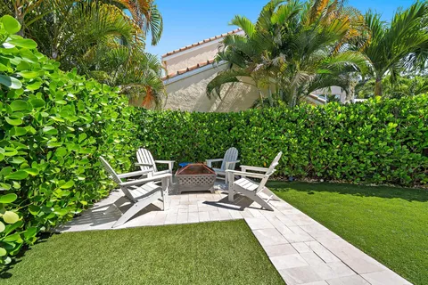 a view of backyard of house with a patio