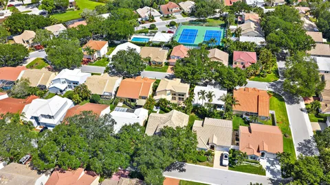 an aerial view of multiple houses with yard